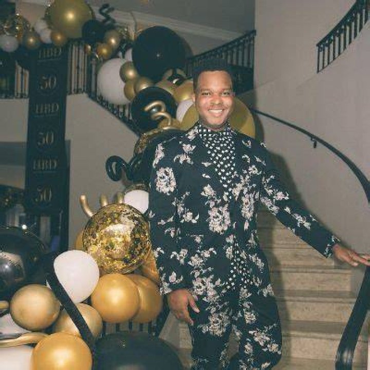 Malachi Jakes is posing in the stairs which has been decorated by balloons.